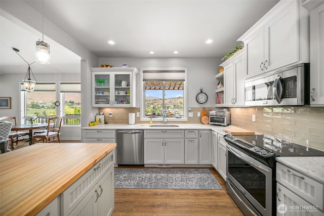 1901 Sleepy Hollow Rd, Wenatchee, WA 98801 - kitchen with stainless steel appliances, butcher block countertops, a sink, dark wood-style floors, and white cabinetry