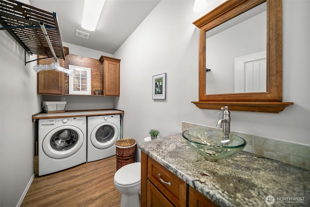 1901 Sleepy Hollow Rd, Wenatchee, WA 98801 - laundry area with washer and dryer, wood finished floors, and baseboards