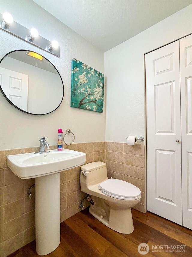 18528 20th Dr SE, Bothell, WA 98012 - bathroom featuring tile walls, toilet, wood finished floors, a wainscoted wall, and a sink
