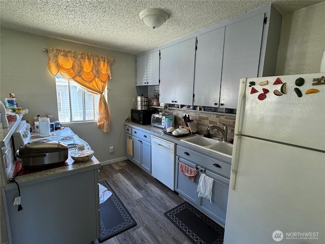 720 S 37th St, Tacoma, WA 98418 - kitchen with white appliances, a sink, dark wood-type flooring, tasteful backsplash, and a textured ceiling