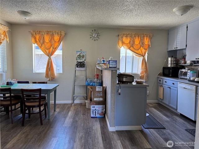 720 S 37th St, Tacoma, WA 98418 - kitchen featuring white dishwasher, a textured ceiling, dark wood-type flooring, black microwave, and baseboards