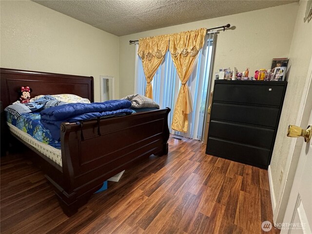 720 S 37th St, Tacoma, WA 98418 - bedroom with wood finished floors and a textured ceiling