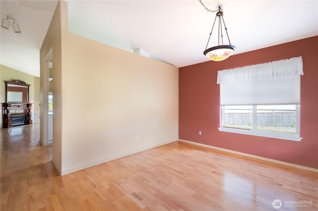 5419 N Court St, Ruston, WA 98407 - unfurnished room with plenty of natural light, light wood-style floors, baseboards, and lofted ceiling