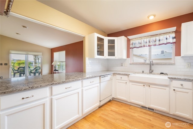 5419 N Court St, Ruston, WA 98407 - kitchen featuring white dishwasher, a sink, tasteful backsplash, white cabinetry, and lofted ceiling