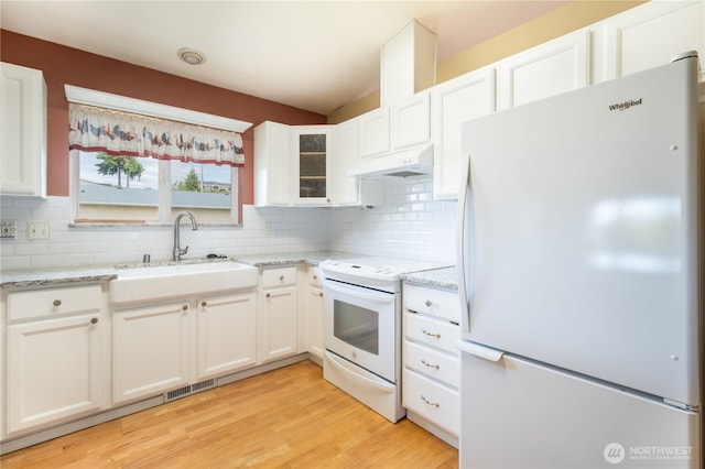 5419 N Court St, Ruston, WA 98407 - kitchen with white appliances, under cabinet range hood, a sink, white cabinets, and lofted ceiling