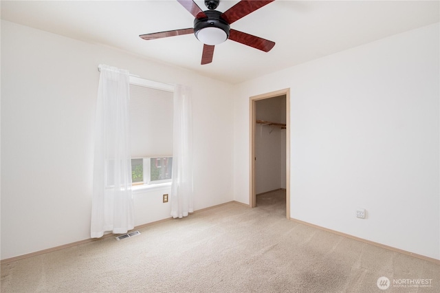 5419 N Court St, Ruston, WA 98407 - unfurnished bedroom with carpet flooring, baseboards, a spacious closet, and a ceiling fan