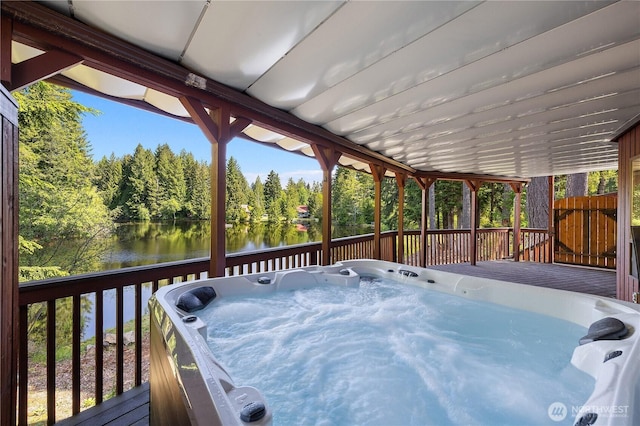 51 E Glamis Ct, Shelton, WA 98584 - deck featuring a water view, a hot tub, and view of wooded area