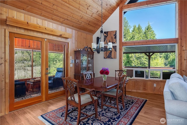 51 E Glamis Ct, Shelton, WA 98584 - dining area with vaulted ceiling, a chandelier, wooden walls, french doors, and wood finished floors
