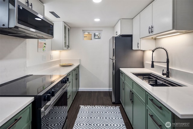 19027 37th Ave S, Seatac, WA 98188 - kitchen featuring stainless steel appliances, green cabinets, a sink, white cabinetry, and recessed lighting
