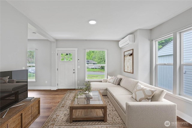 45885 Division St, Concrete, WA 98237 - living area featuring healthy amount of natural light, an AC wall unit, wood finished floors, baseboards, and recessed lighting