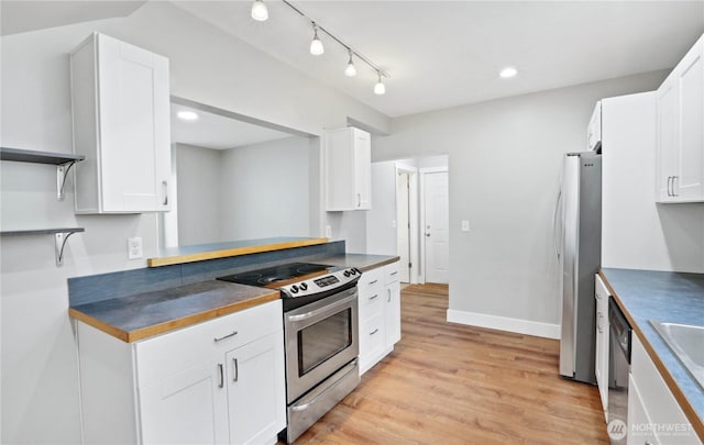 45885 Division St, Concrete, WA 98237 - kitchen featuring stainless steel appliances, open shelves, white cabinets, light wood-style floors, and recessed lighting