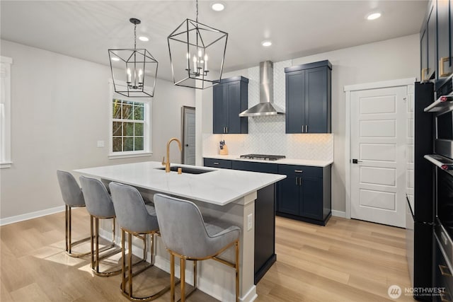 14205 272nd Pl NE, Duvall, WA 98019 - kitchen featuring a sink, wall chimney exhaust hood, gas stovetop, a kitchen bar, and backsplash