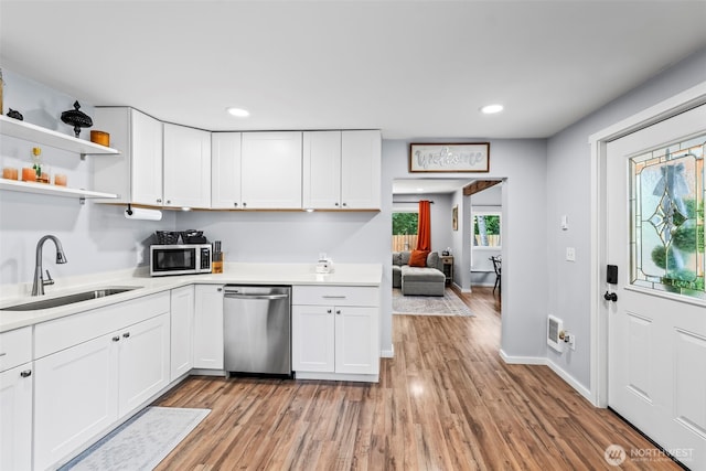 140 Tremont St, Port Orchard, WA 98366 - kitchen with stainless steel appliances, a sink, white cabinets, and recessed lighting