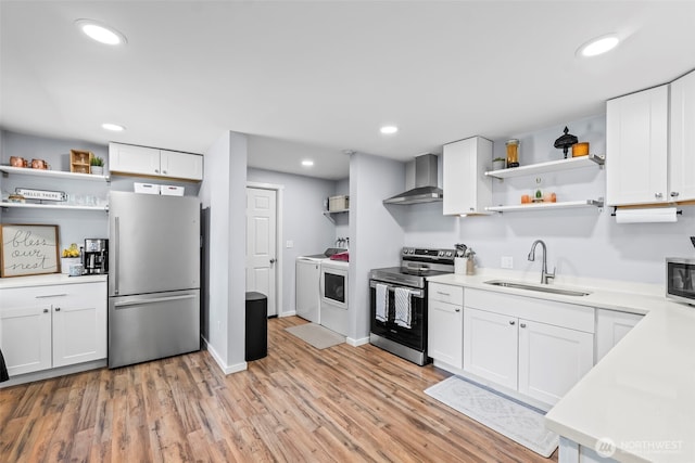 140 Tremont St, Port Orchard, WA 98366 - kitchen with stainless steel appliances, open shelves, wall chimney range hood, washing machine and clothes dryer, and a sink