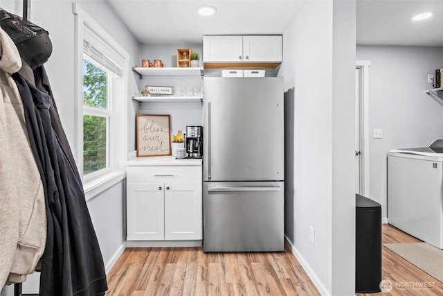 140 Tremont St, Port Orchard, WA 98366 - kitchen with freestanding refrigerator, washer / dryer, light wood-type flooring, white cabinets, and recessed lighting