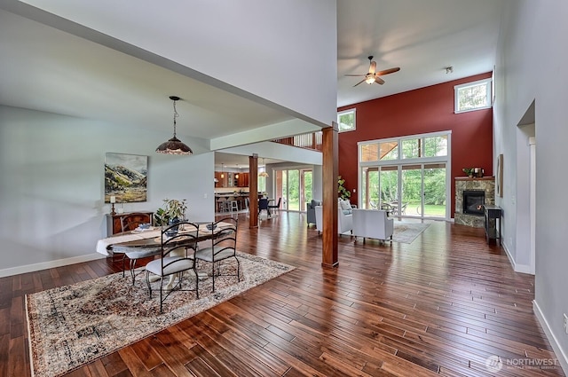 936 W Axton Rd, Bellingham, WA 98226 - dining space featuring a towering ceiling, ceiling fan, a glass covered fireplace, hardwood / wood-style flooring, and baseboards