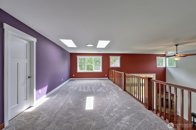 936 W Axton Rd, Bellingham, WA 98226 - carpeted spare room featuring a skylight, a ceiling fan, and baseboards
