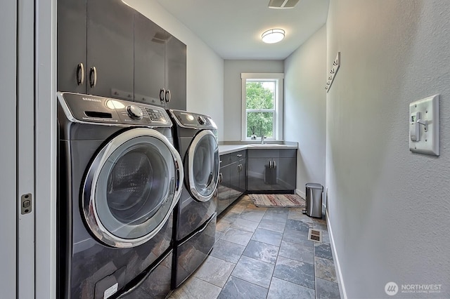 936 W Axton Rd, Bellingham, WA 98226 - laundry room featuring cabinet space, washer and clothes dryer, stone finish floors, and baseboards