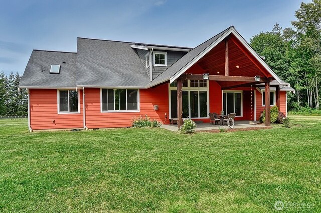 936 W Axton Rd, Bellingham, WA 98226 - rear view of house featuring a patio area, a lawn, and roof with shingles