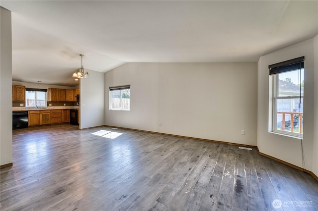 912 Eagle Crest Pl, Port Orchard, WA 98366 - unfurnished living room with a chandelier, healthy amount of natural light, wood finished floors, vaulted ceiling, and baseboards