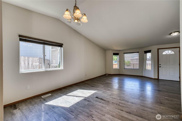 912 Eagle Crest Pl, Port Orchard, WA 98366 - spare room featuring a chandelier, vaulted ceiling, wood finished floors, and baseboards
