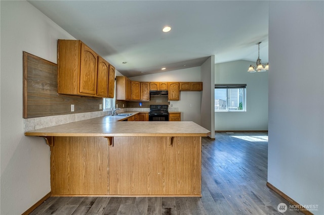 912 Eagle Crest Pl, Port Orchard, WA 98366 - kitchen with range, lofted ceiling, a sink, a peninsula, and range hood