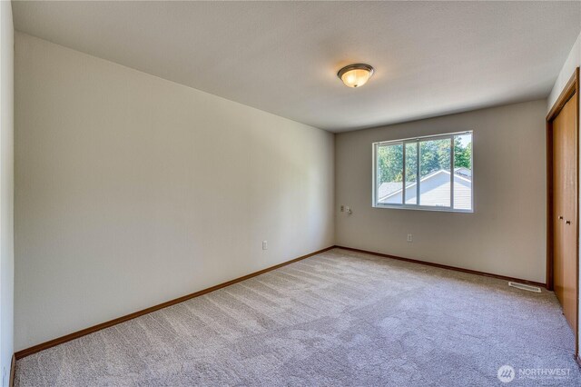 912 Eagle Crest Pl, Port Orchard, WA 98366 - spare room featuring light colored carpet and baseboards