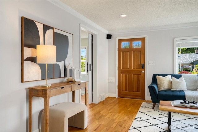 7530 25th Ave NW, Seattle, WA 98117 - foyer featuring a textured ceiling, light wood finished floors, ornamental molding, baseboards, and recessed lighting
