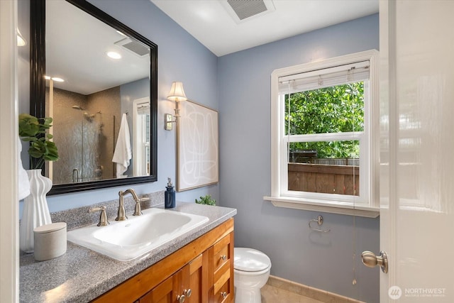 7530 25th Ave NW, Seattle, WA 98117 - full bathroom featuring vanity, a stall shower, toilet, tile patterned flooring, and baseboards