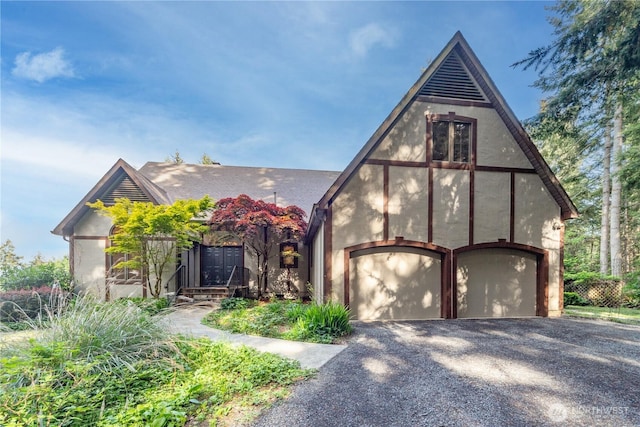 160 Bywater Way, Port Ludlow, WA 98365 - view of front of property with gravel driveway, a garage, and stucco siding