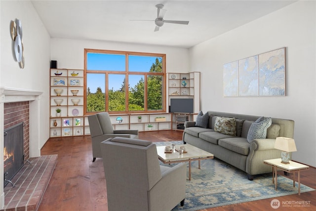160 Bywater Way, Port Ludlow, WA 98365 - living room with wood finished floors, a ceiling fan, and a brick fireplace