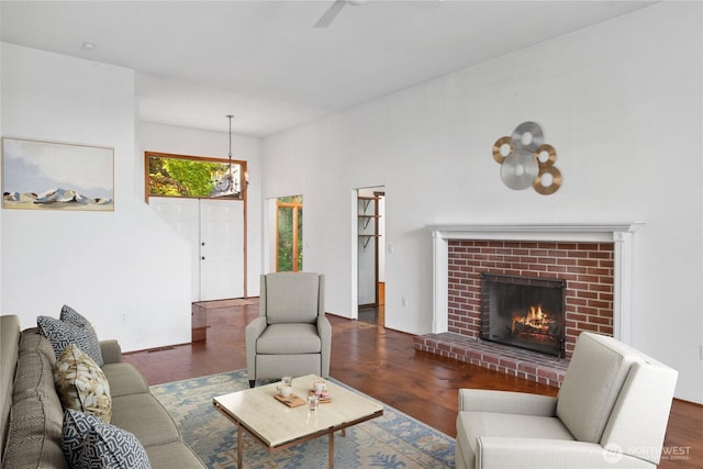 160 Bywater Way, Port Ludlow, WA 98365 - living room featuring wood finished floors, a fireplace, a ceiling fan, and a chandelier