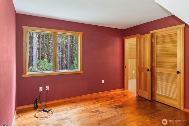 160 Bywater Way, Port Ludlow, WA 98365 - unfurnished bedroom featuring hardwood / wood-style floors, a closet, and baseboards