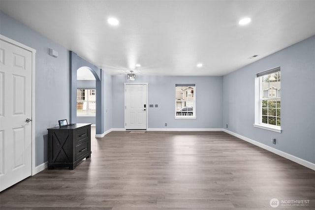 20723 197th Ave E, Orting, WA 98360 - foyer entrance featuring arched walkways, recessed lighting, healthy amount of natural light, dark wood-type flooring, and baseboards