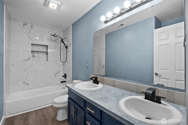 20723 197th Ave E, Orting, WA 98360 - bathroom featuring toilet, double vanity, washtub / shower combination, and wood finished floors