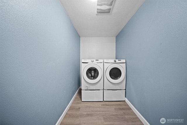 20723 197th Ave E, Orting, WA 98360 - washroom with washer and clothes dryer, baseboards, and wood finished floors