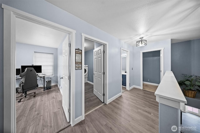 20723 197th Ave E, Orting, WA 98360 - corridor with washer / dryer, wood finished floors, baseboards, and an office area