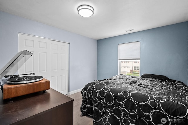 20723 197th Ave E, Orting, WA 98360 - bedroom featuring wood finished floors, a closet, and baseboards