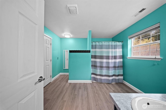 20723 197th Ave E, Orting, WA 98360 - full bathroom with wood finished floors, baseboards, vanity, and a shower with curtain