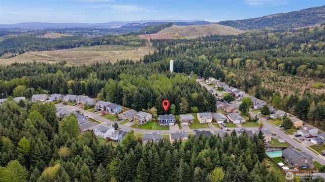 20723 197th Ave E, Orting, WA 98360 - aerial view of property and surrounding area featuring a forest, a mountainous background, and nearby suburban area