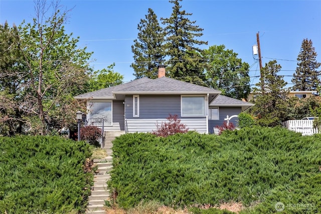 813 E 3rd Ave, Ellensburg, WA 98926 - view of front facade with stairs, a chimney, and a shingled roof