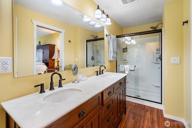14945 Fox Hill Rd SE, Yelm, WA 98597 - full bath with ensuite bathroom, a shower stall, wood finished floors, and double vanity