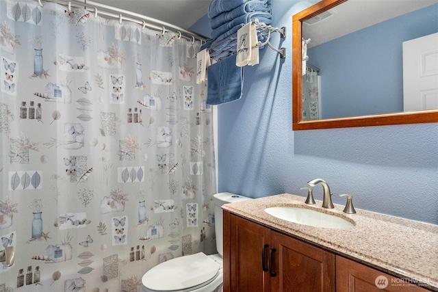 14945 Fox Hill Rd SE, Yelm, WA 98597 - full bathroom featuring toilet, vanity, a textured wall, and a shower with curtain