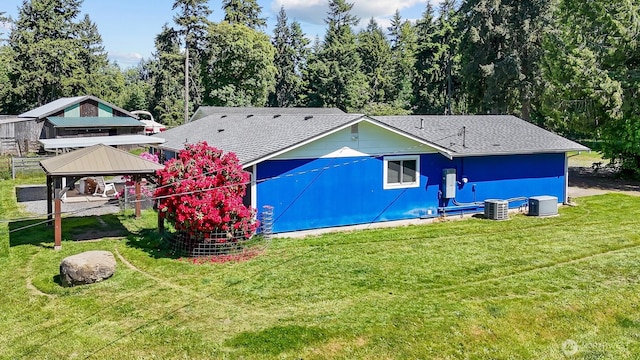 14945 Fox Hill Rd SE, Yelm, WA 98597 - back of property with a gazebo, a shingled roof, a lawn, and cooling unit