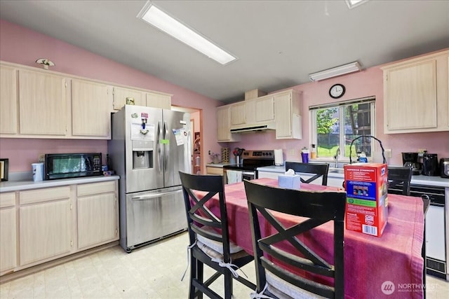 741 Twin Lakes Rd, Cle Elum, WA 98922 - kitchen with appliances with stainless steel finishes, vaulted ceiling, under cabinet range hood, light countertops, and light flooring