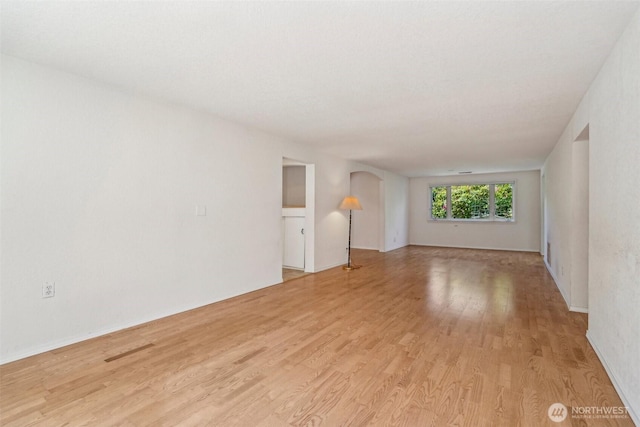 11112 E Riverside Dr, Bothell, WA 98011 - unfurnished room with arched walkways and light wood-type flooring