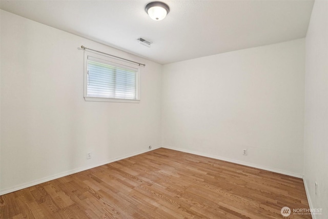 11112 E Riverside Dr, Bothell, WA 98011 - empty room featuring light wood-style flooring and baseboards