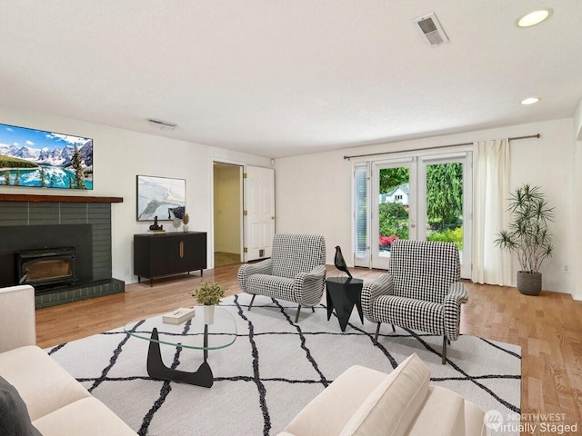 11112 E Riverside Dr, Bothell, WA 98011 - living area featuring wood finished floors, a brick fireplace, and recessed lighting