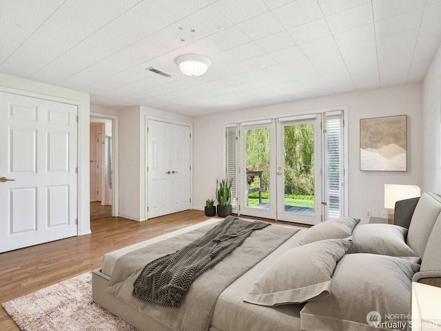 11112 E Riverside Dr, Bothell, WA 98011 - bedroom featuring access to exterior, wood finished floors, and a closet