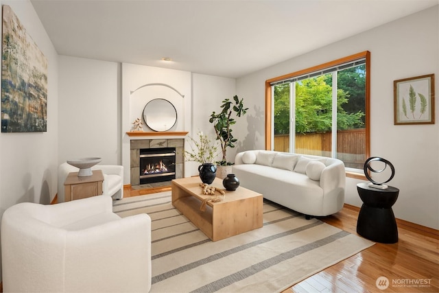 7522 NE 204th Pl, Kenmore, WA 98028 - living room featuring wood finished floors, a fireplace, and baseboards